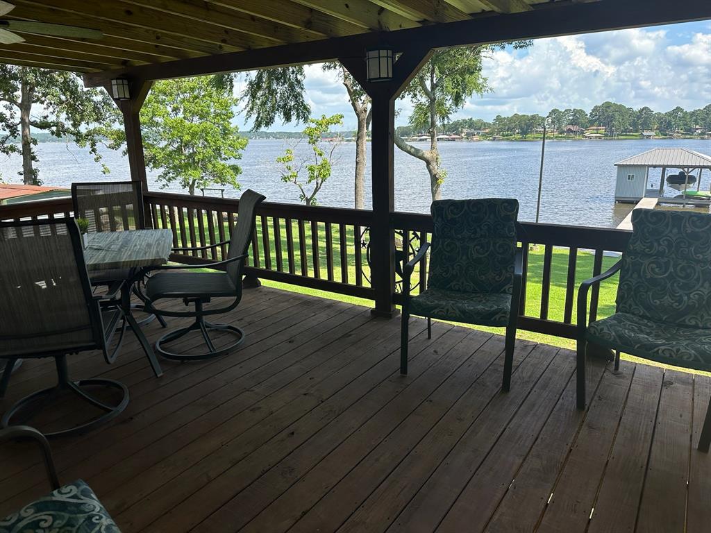 21516 Water Ridge Road Chandler, TX 75758 - Photo 22 of 40 a view of a porch with furniture and wooden floor