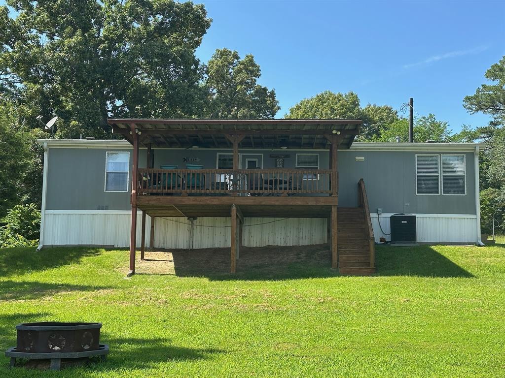 21516 Water Ridge Road Chandler, TX 75758 - Photo 23 of 40 a view of house with backyard outdoor seating and entertaining space