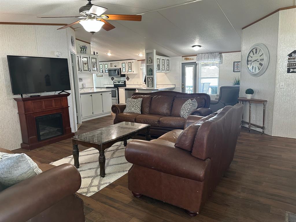 21516 Water Ridge Road Chandler, TX 75758 - Photo 4 of 40 a living room with furniture a flat screen tv and kitchen view