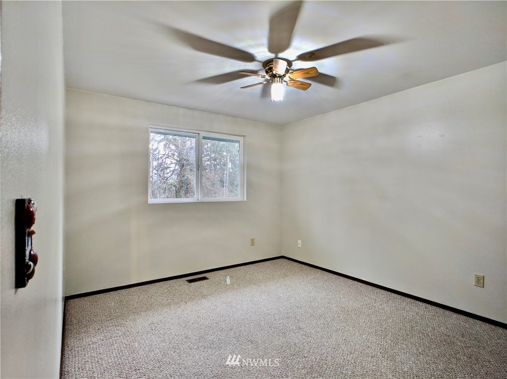 17819 Southeast 137th Street Renton, WA 98059 - Photo 21 of 37 an empty room with a window and a fan