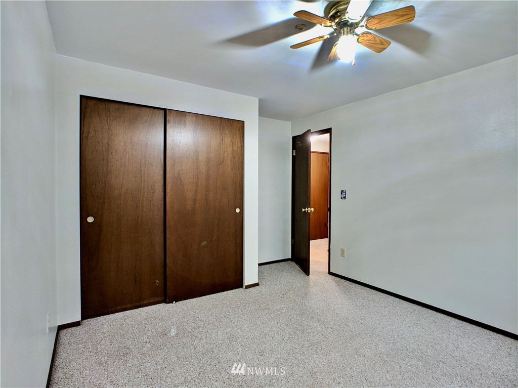 17819 Southeast 137th Street Renton, WA 98059 - Photo 22 of 37 a view of an empty room with window and a chandelier fan