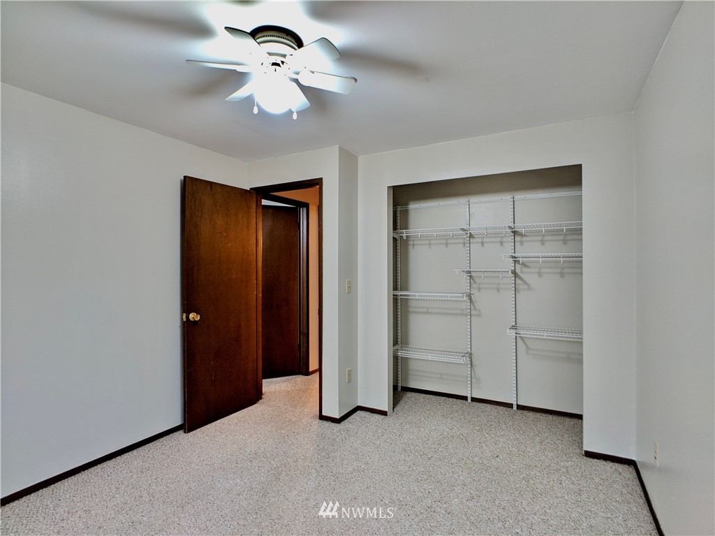 17819 Southeast 137th Street Renton, WA 98059 - Photo 24 of 37 an empty room with closet and a ceiling fan