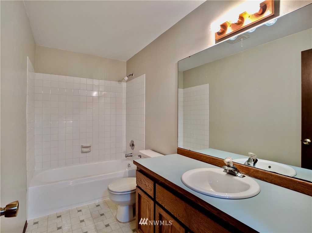 17819 Southeast 137th Street Renton, WA 98059 - Photo 26 of 37 a bathroom with a sink a toilet a tub and shower