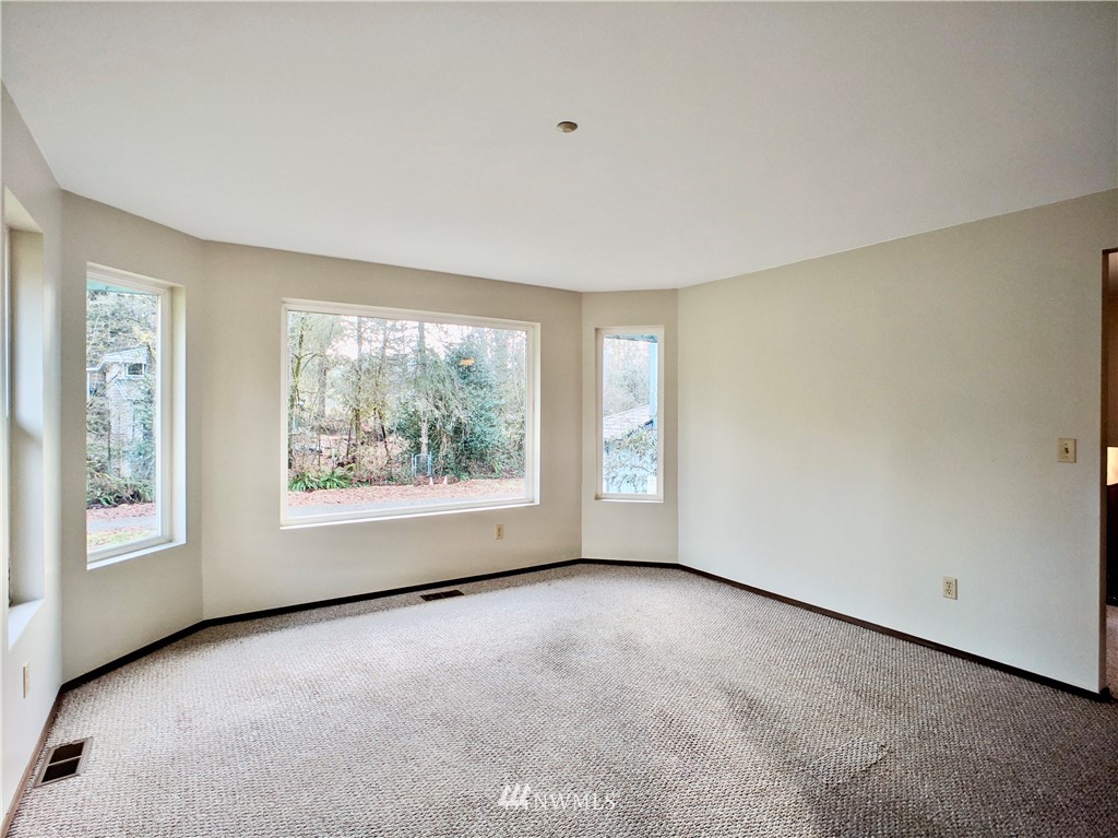 17819 Southeast 137th Street Renton, WA 98059 - Photo 6 of 37 a view of a big room with windows and chandelier fan