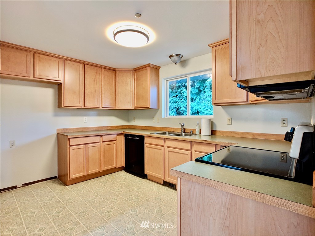17819 Southeast 137th Street Renton, WA 98059 - Photo 8 of 37 a kitchen with stainless steel appliances granite countertop a sink and a stove