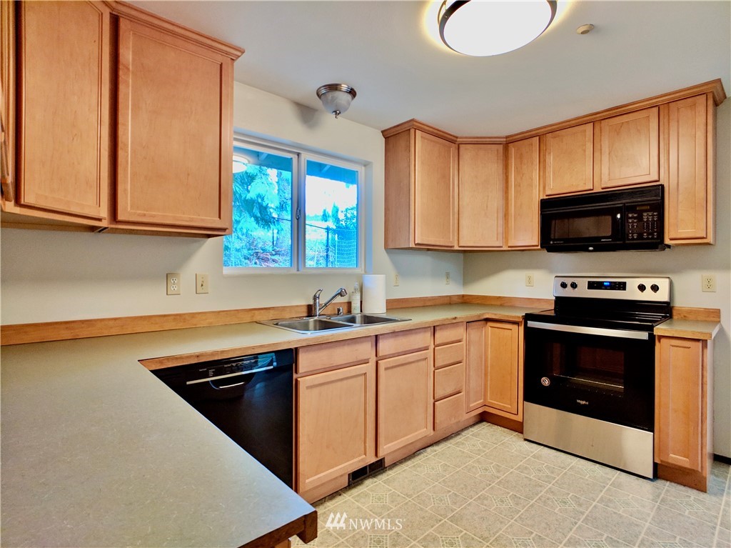 17819 Southeast 137th Street Renton, WA 98059 - Photo 9 of 37 a kitchen with stainless steel appliances a stove sink and microwave