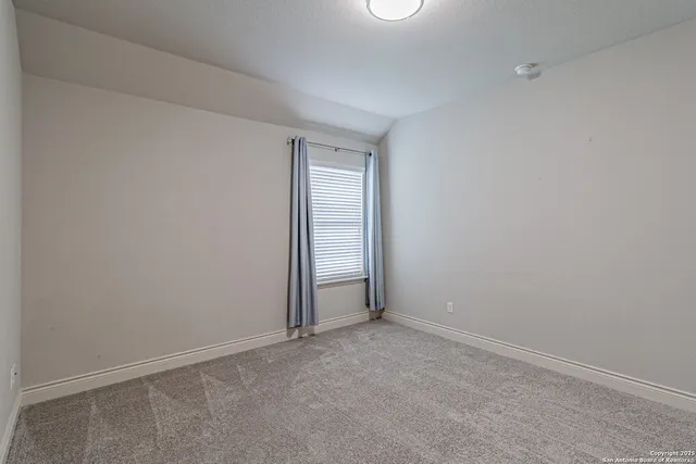 a view of an empty room and closet area