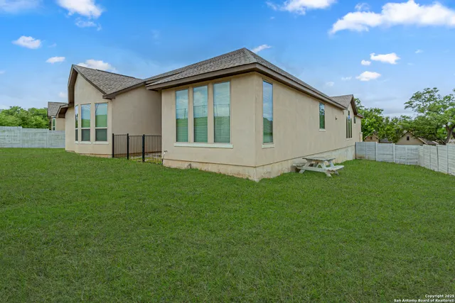 a view of an house with backyard space and garden