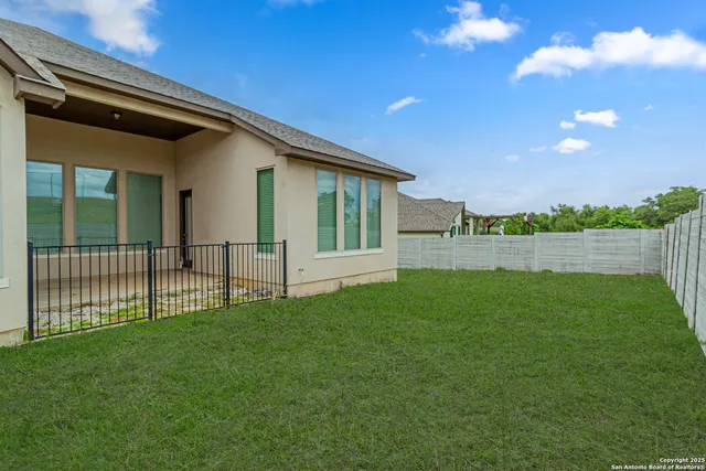 a view of a house with backyard and porch