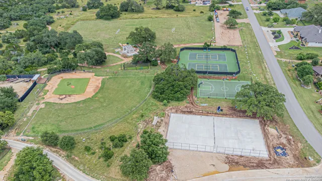 an aerial view of a house with a yard basket ball court and outdoor seating