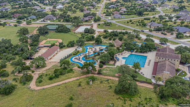 an aerial view of residential houses with outdoor space and street view