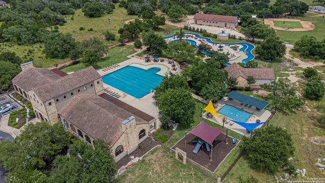 an aerial view of house with yard swimming pool and outdoor seating