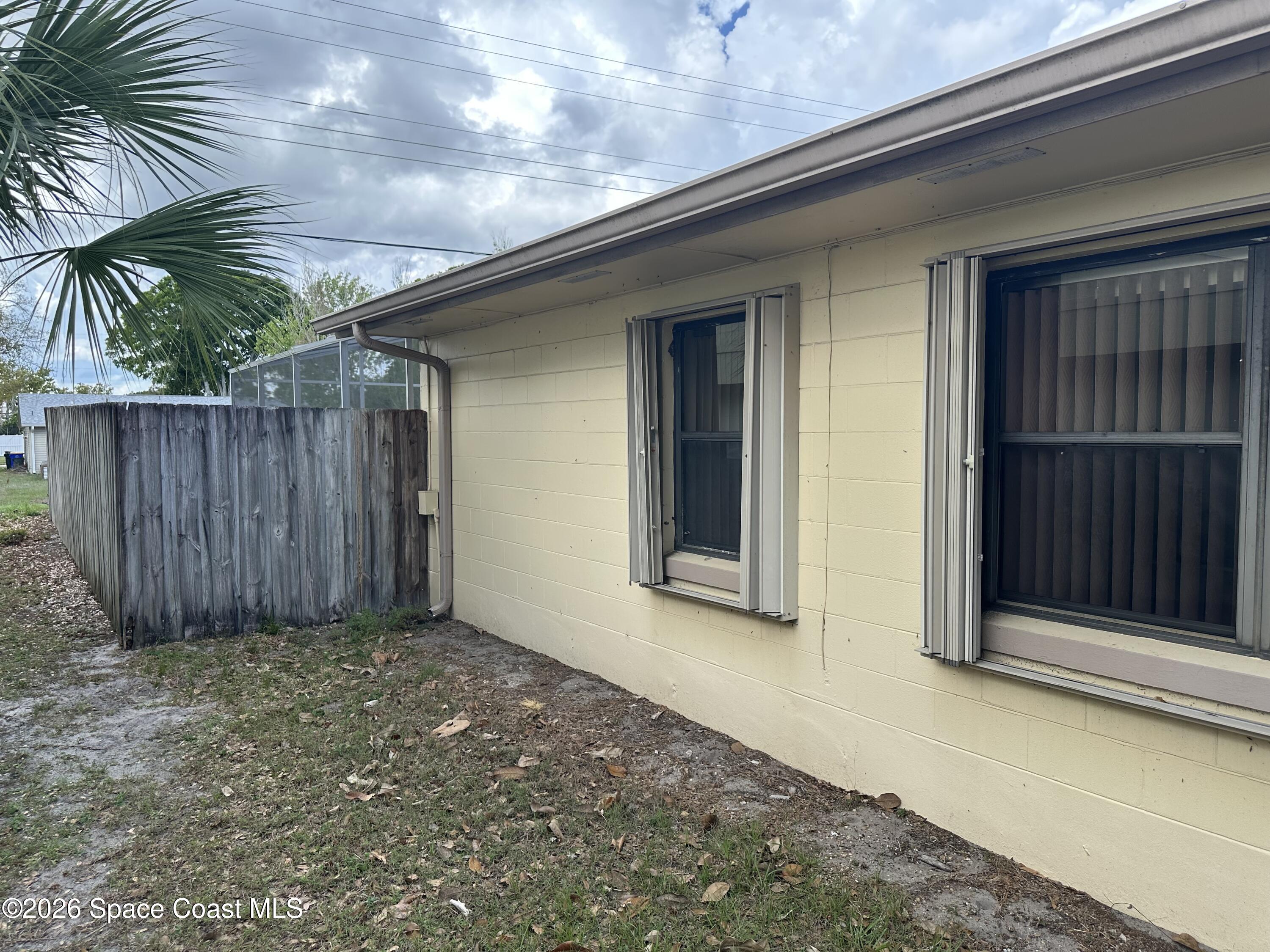 995 Botany Lane Rockledge, FL 32955 - Photo 46 of 64 a view of backyard with potted plants and wooden fence