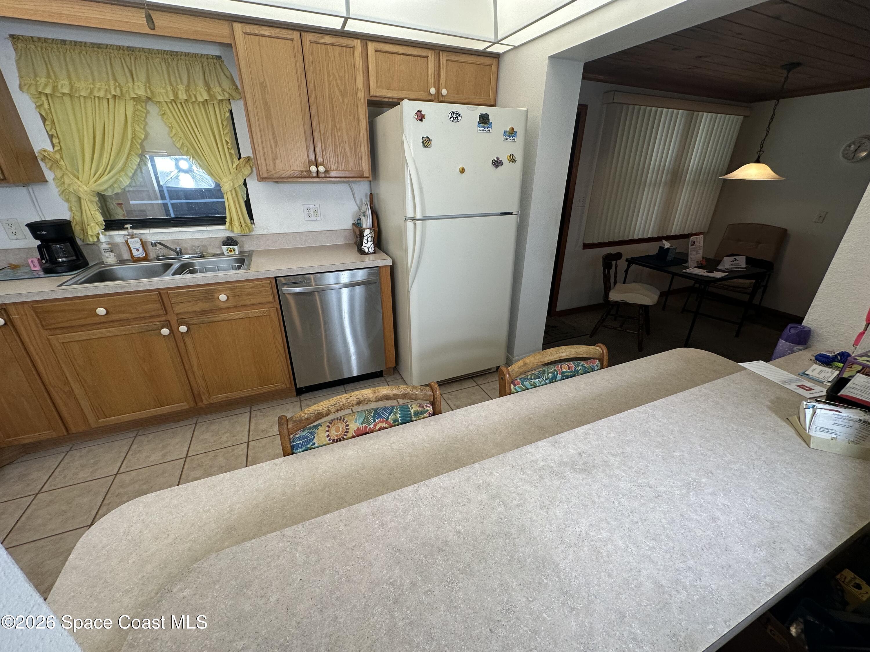 995 Botany Lane Rockledge, FL 32955 - Photo 51 of 64 a kitchen with refrigerator and window