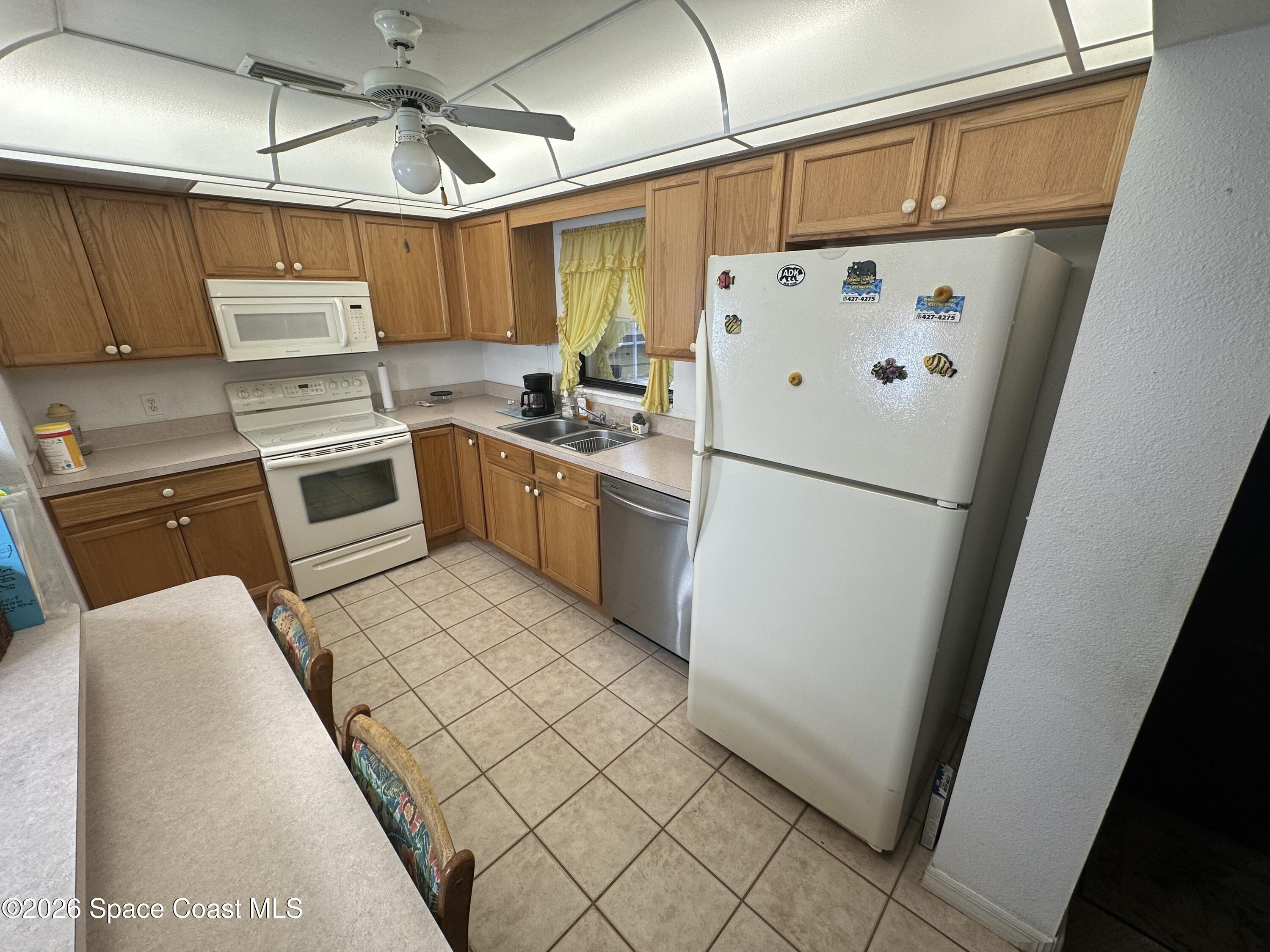 995 Botany Lane Rockledge, FL 32955 - Photo 52 of 64 a kitchen with stainless steel appliances a refrigerator sink and cabinets