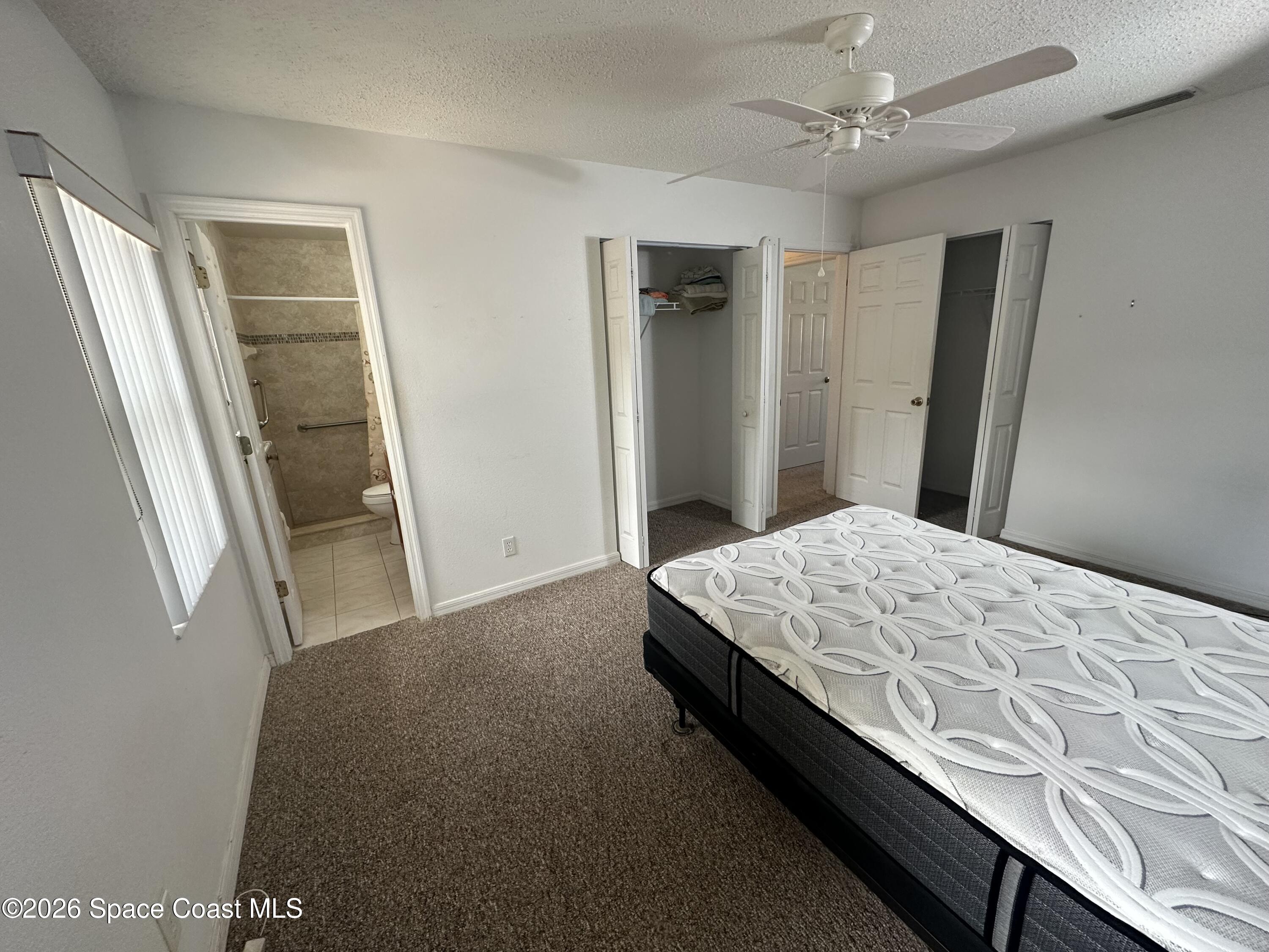 995 Botany Lane Rockledge, FL 32955 - Photo 55 of 64 a bedroom with a bed and a mirror