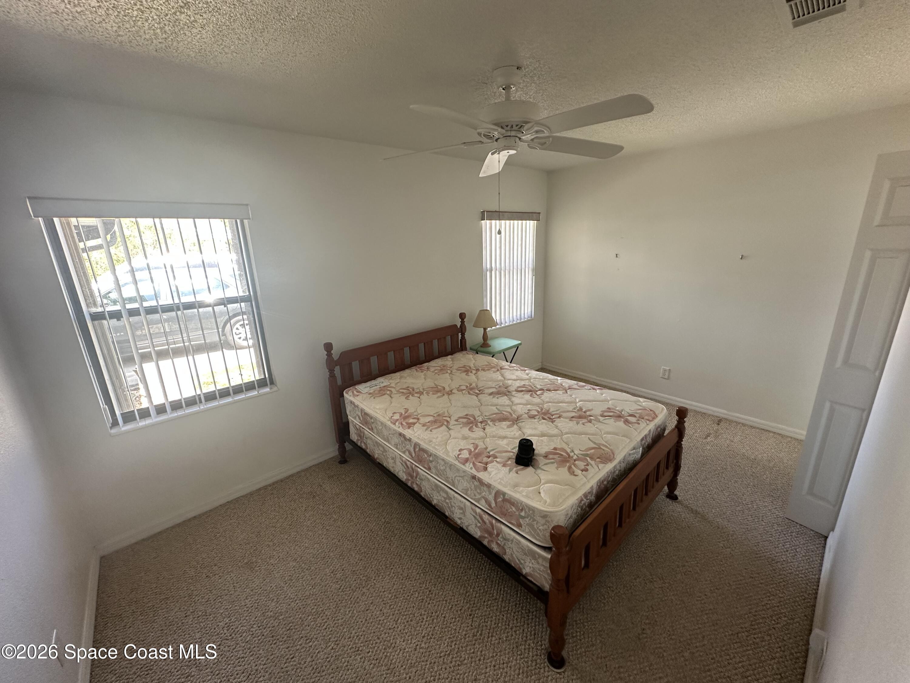 995 Botany Lane Rockledge, FL 32955 - Photo 57 of 64 a room with a bed and window