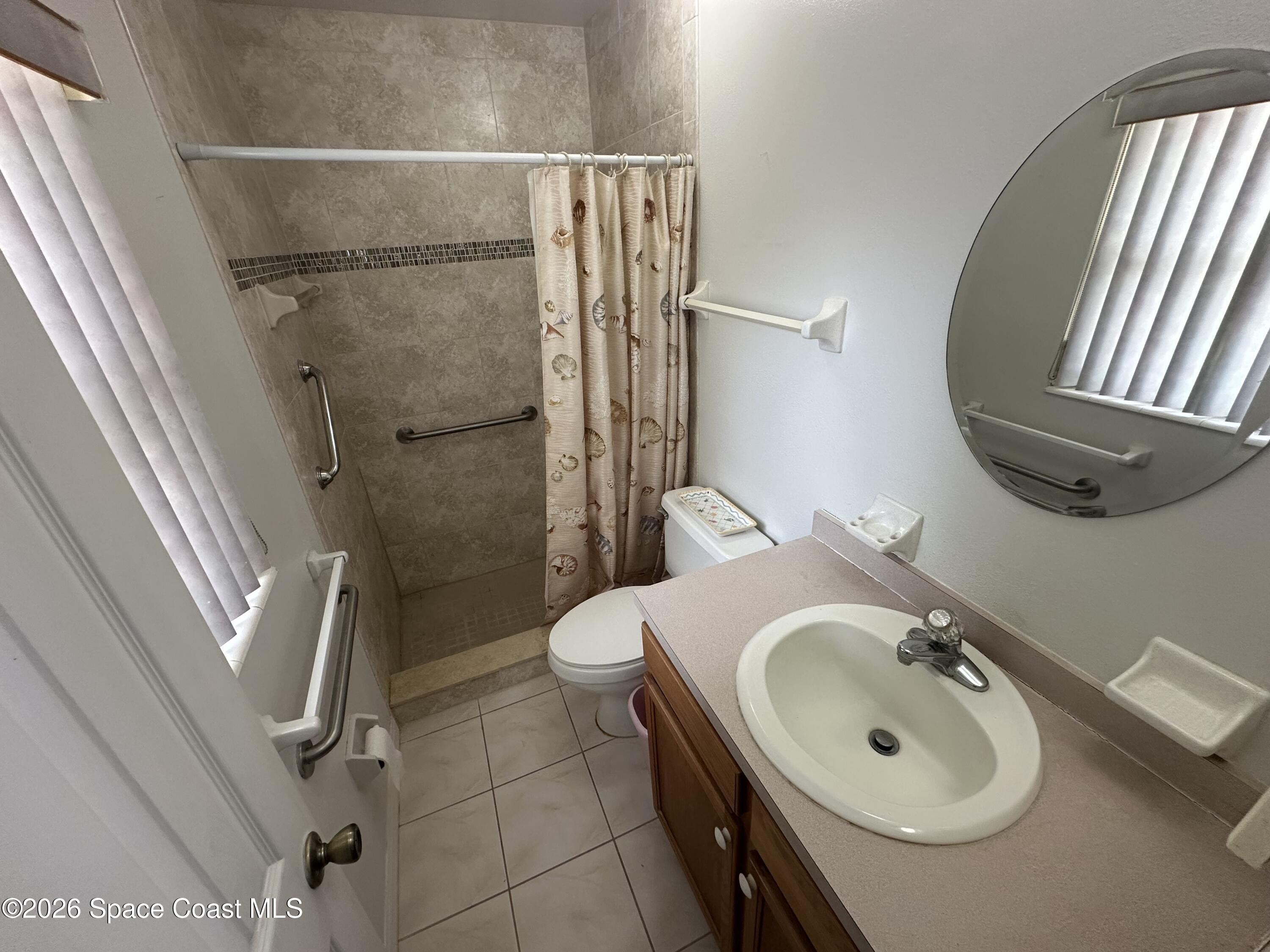 995 Botany Lane Rockledge, FL 32955 - Photo 60 of 64 a bathroom with a sink a toilet and shower