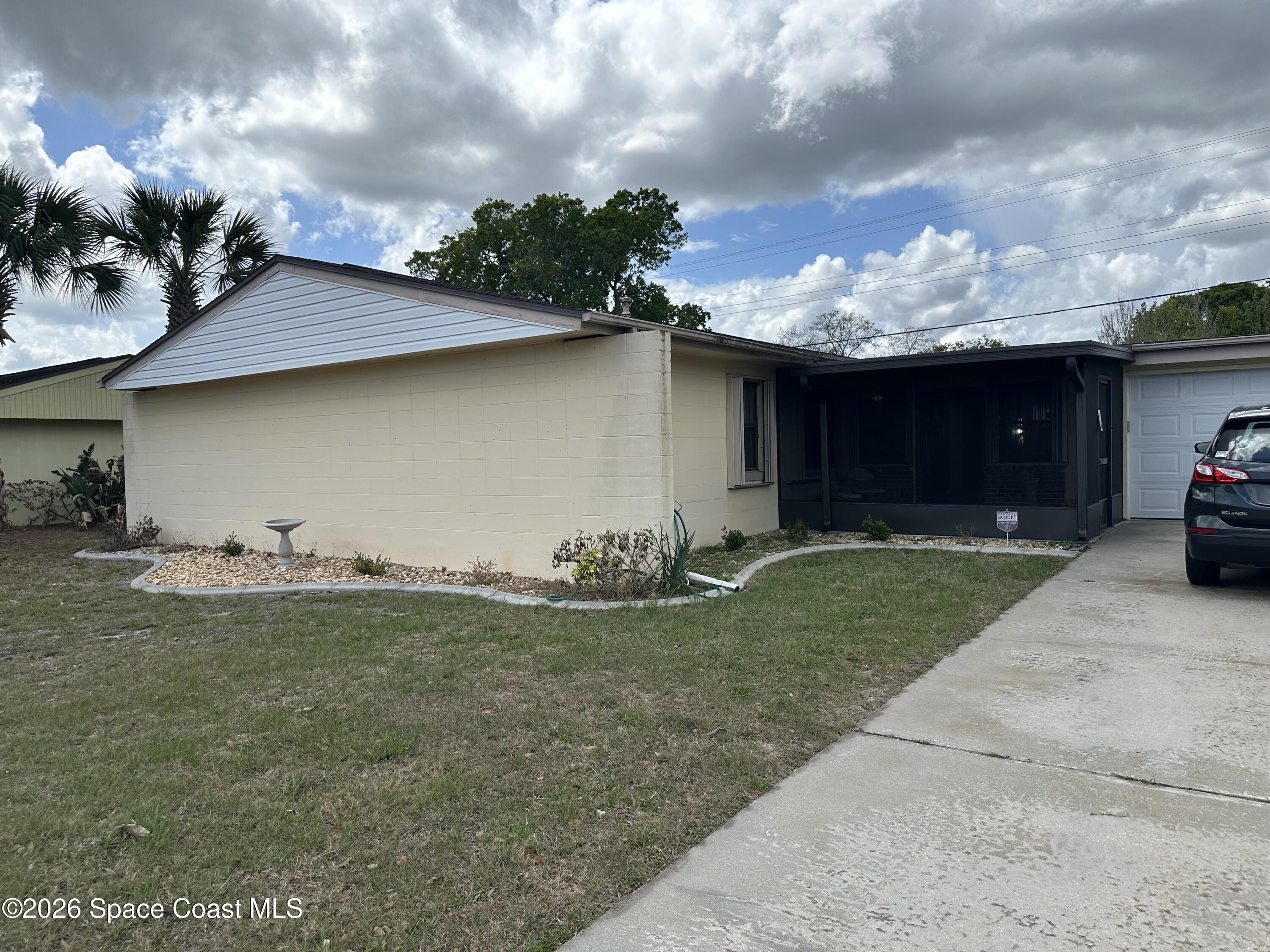 995 Botany Lane Rockledge, FL 32955 - Photo 61 of 64 a front view of a house with garden