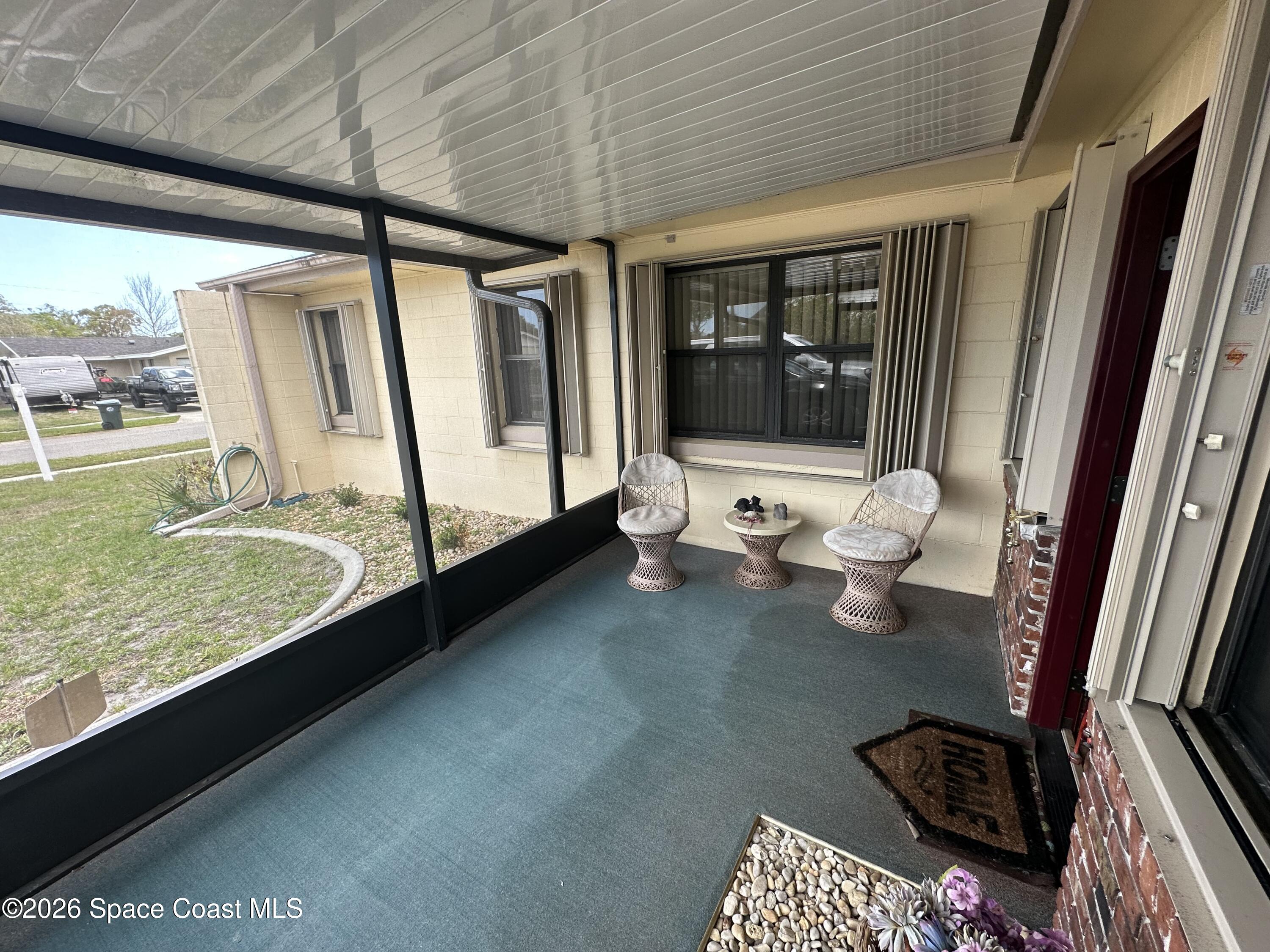 995 Botany Lane Rockledge, FL 32955 - Photo 63 of 64 a living room with furniture and a flat screen tv