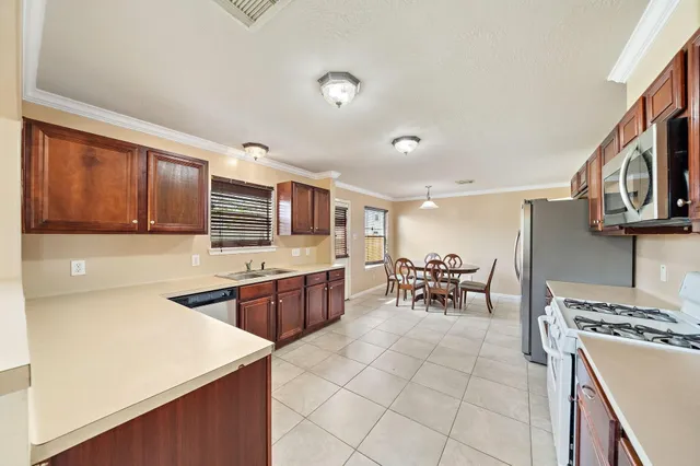 a kitchen with stainless steel appliances granite countertop a sink and cabinets