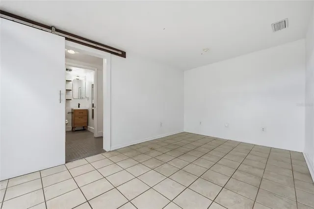 a view of an empty room and hallway