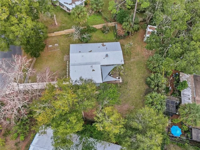 an aerial view of a house with a yard