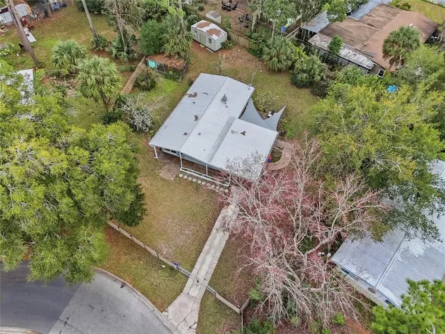 an aerial view of a house with a yard