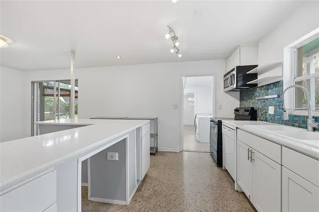 a kitchen with a sink and cabinets