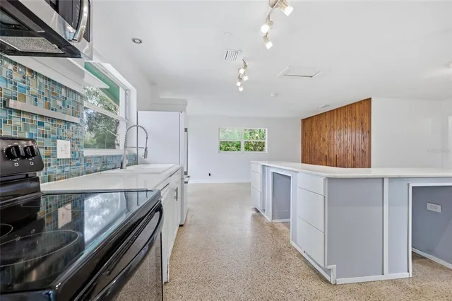 a view of a kitchen with a sink and dishwasher wooden floor