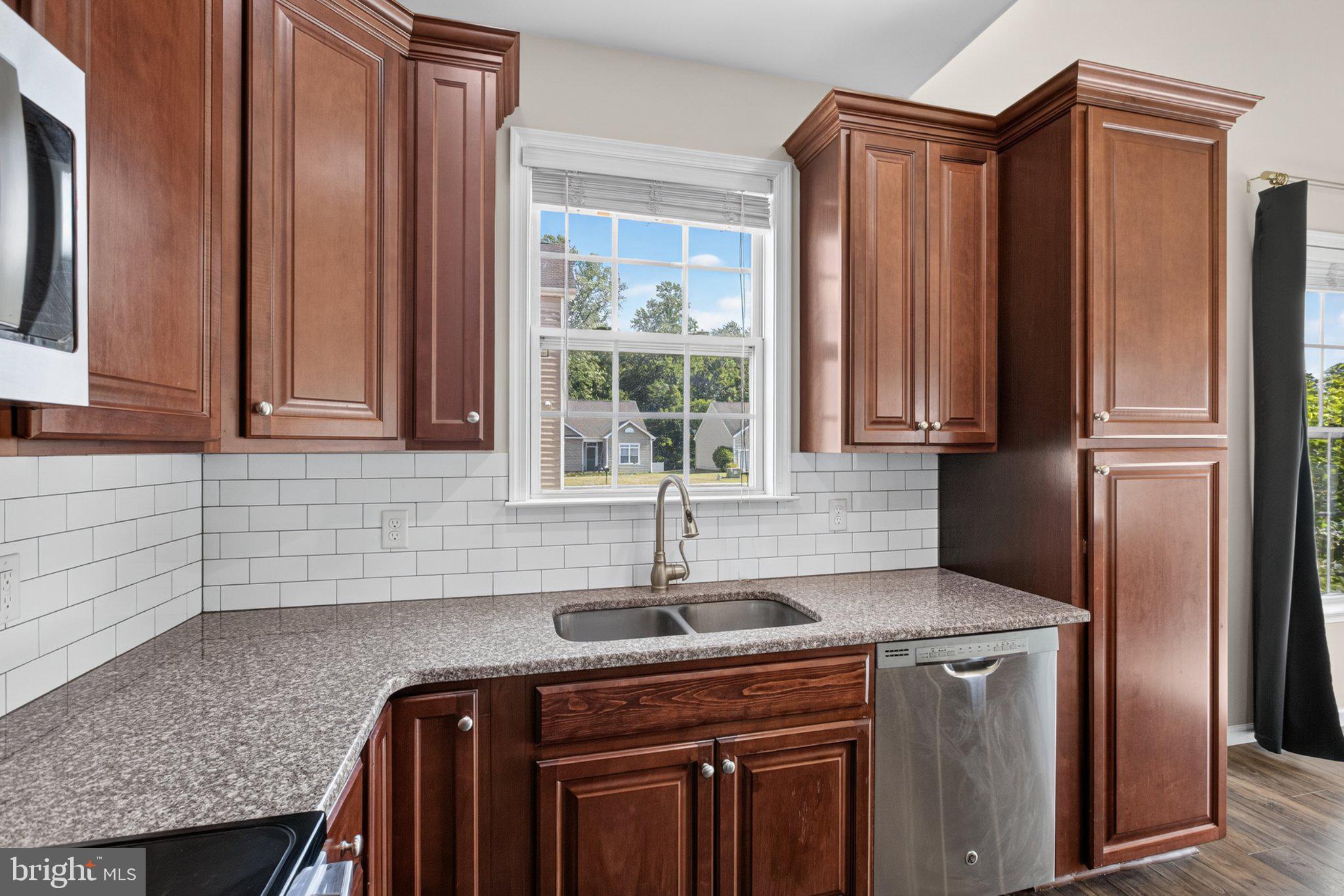 27 Sun Ridge Drive Felton, DE 19943 - Photo 22 of 61 Warm wood tones in a bright kitchen.