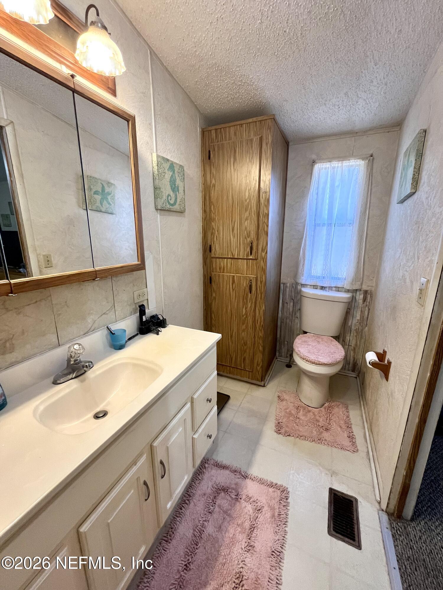 174 Buchanan Circle Satsuma, FL 32189 - Photo 11 of 16 a spacious bathroom with a tub sink and mirror