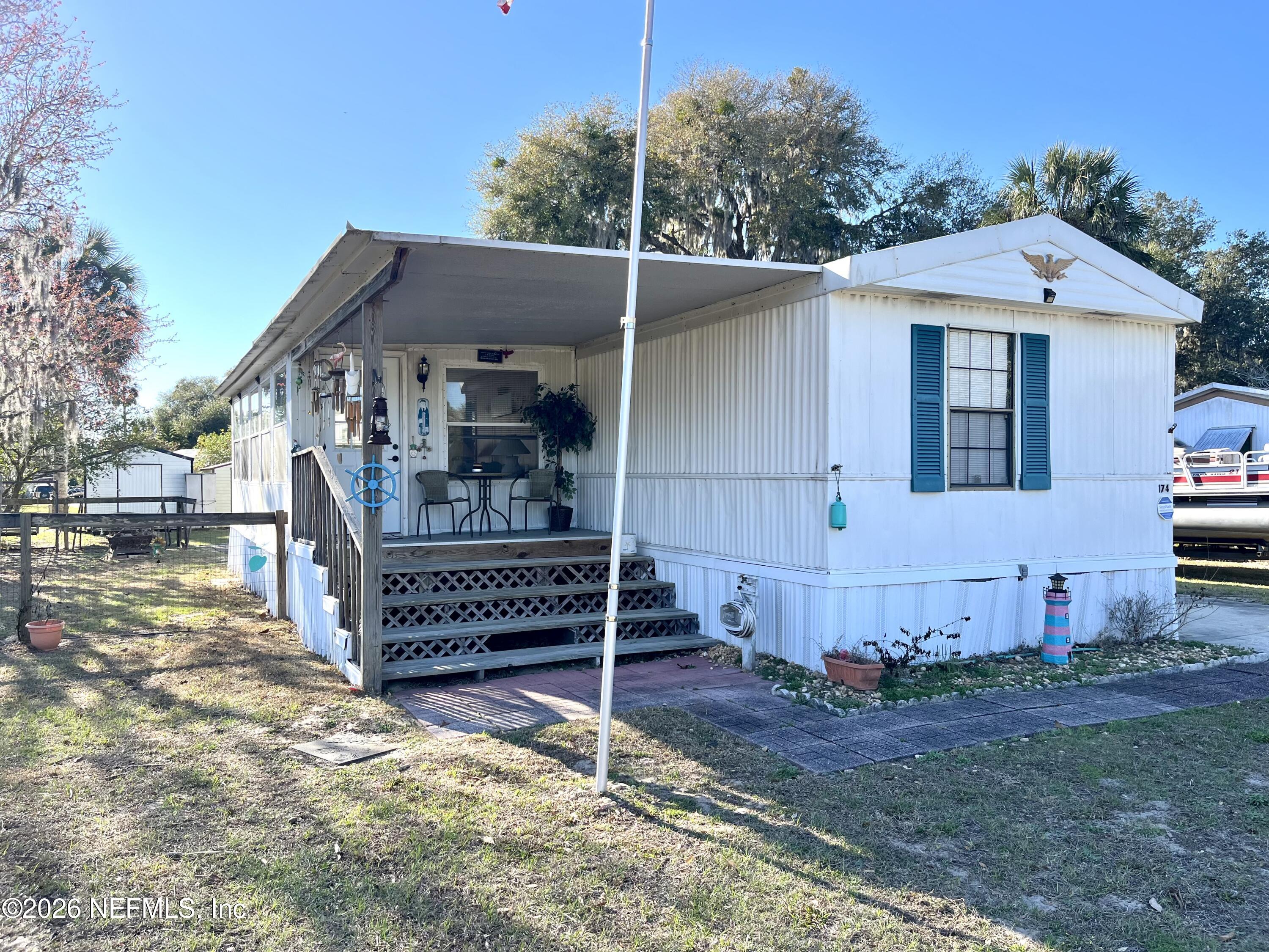 174 Buchanan Circle Satsuma, FL 32189 - Photo 2 of 16 a front view of a house with a yard