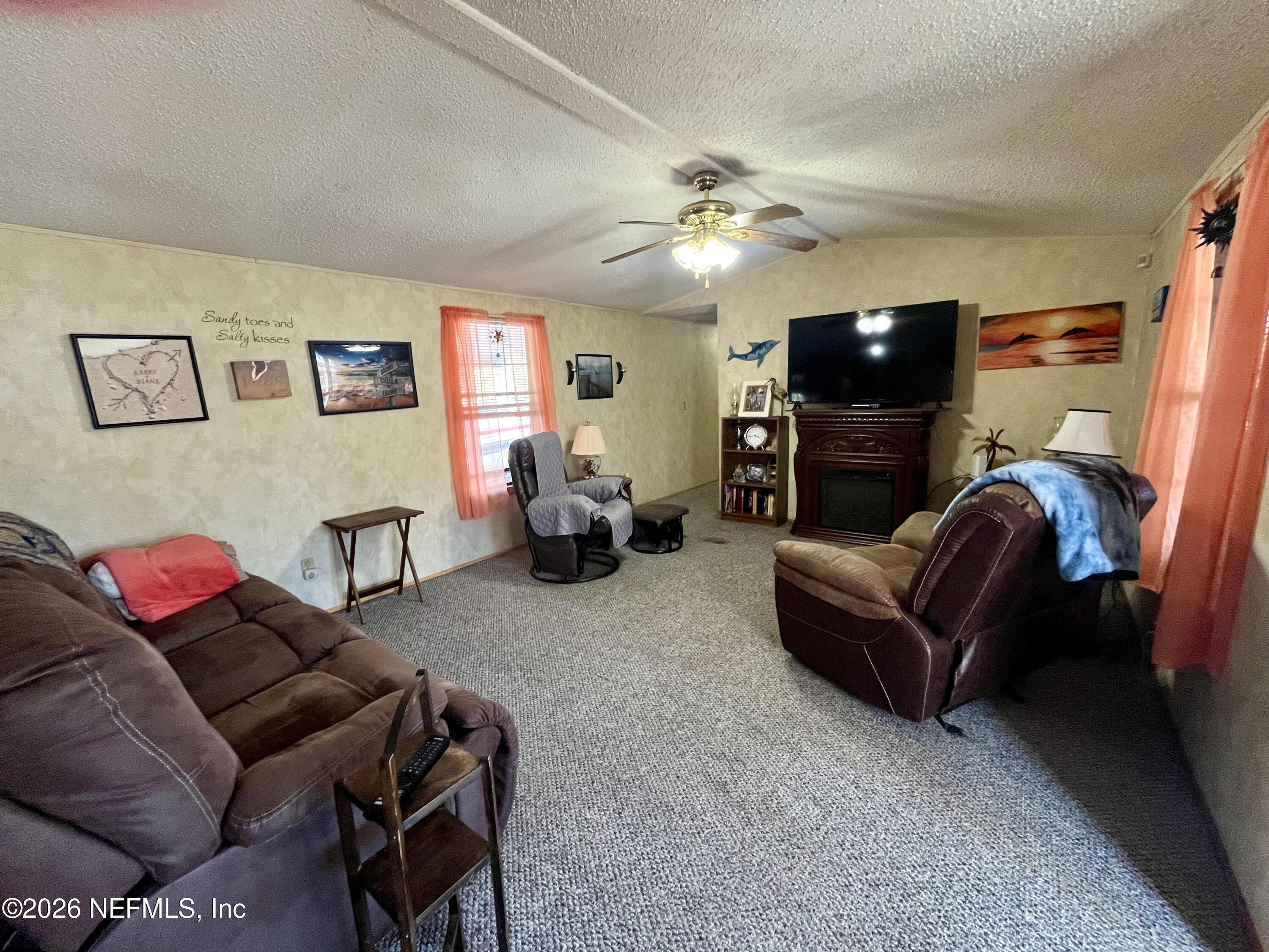 174 Buchanan Circle Satsuma, FL 32189 - Photo 4 of 16 a living room with furniture and a flat screen tv