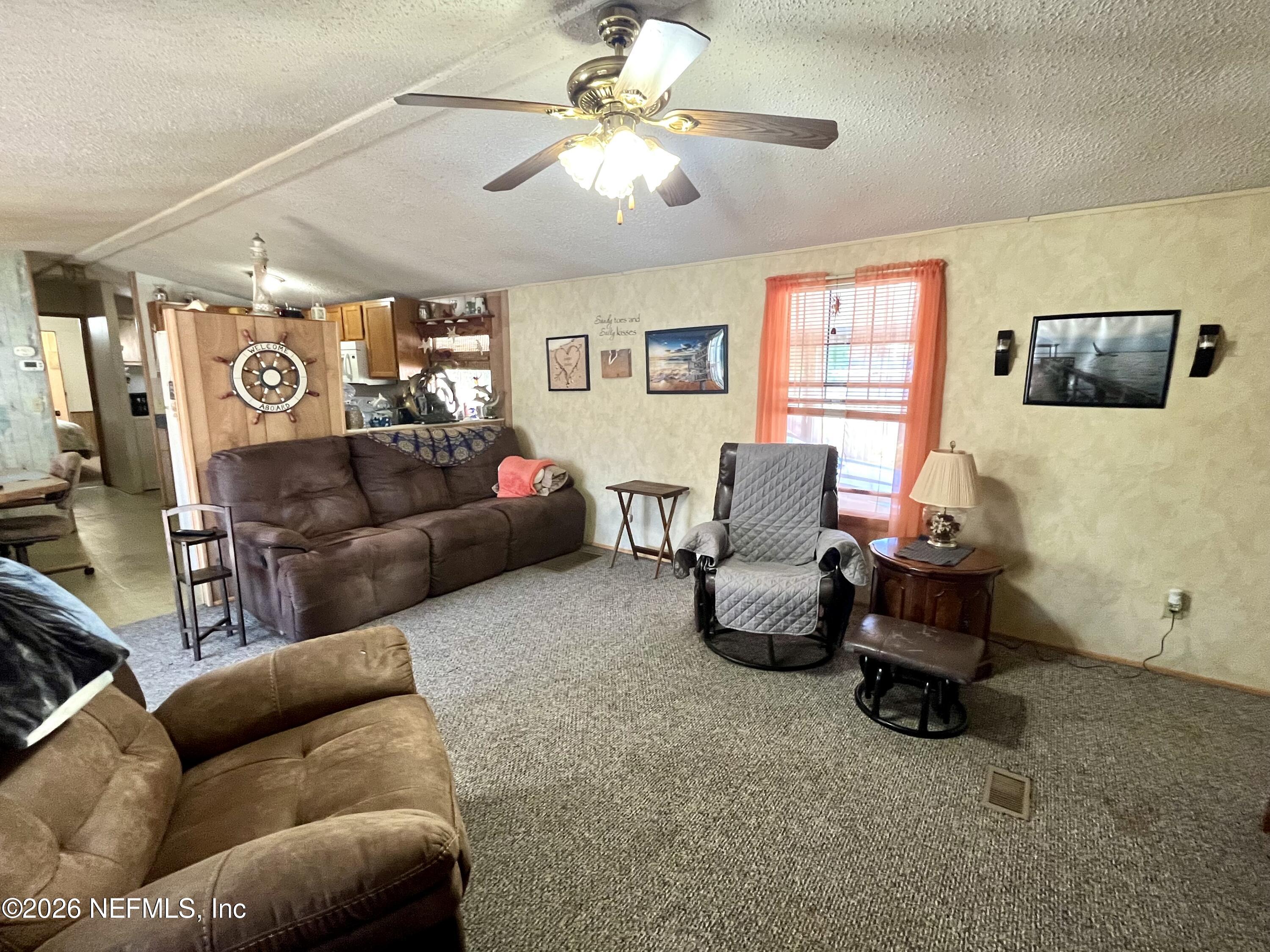 174 Buchanan Circle Satsuma, FL 32189 - Photo 6 of 16 a living room with furniture and a window