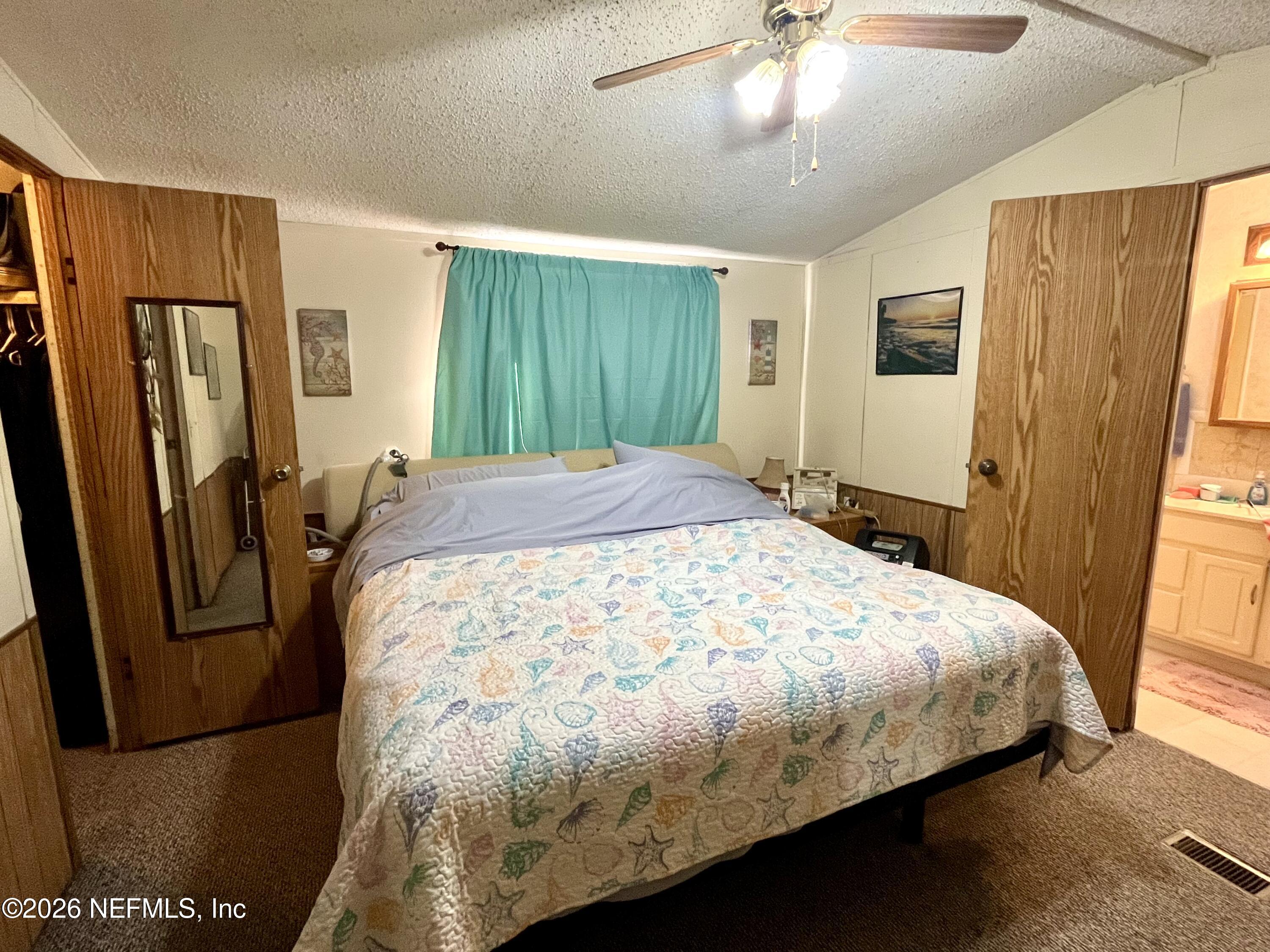 174 Buchanan Circle Satsuma, FL 32189 - Photo 8 of 16 a large bed sitting in a bedroom next to a window