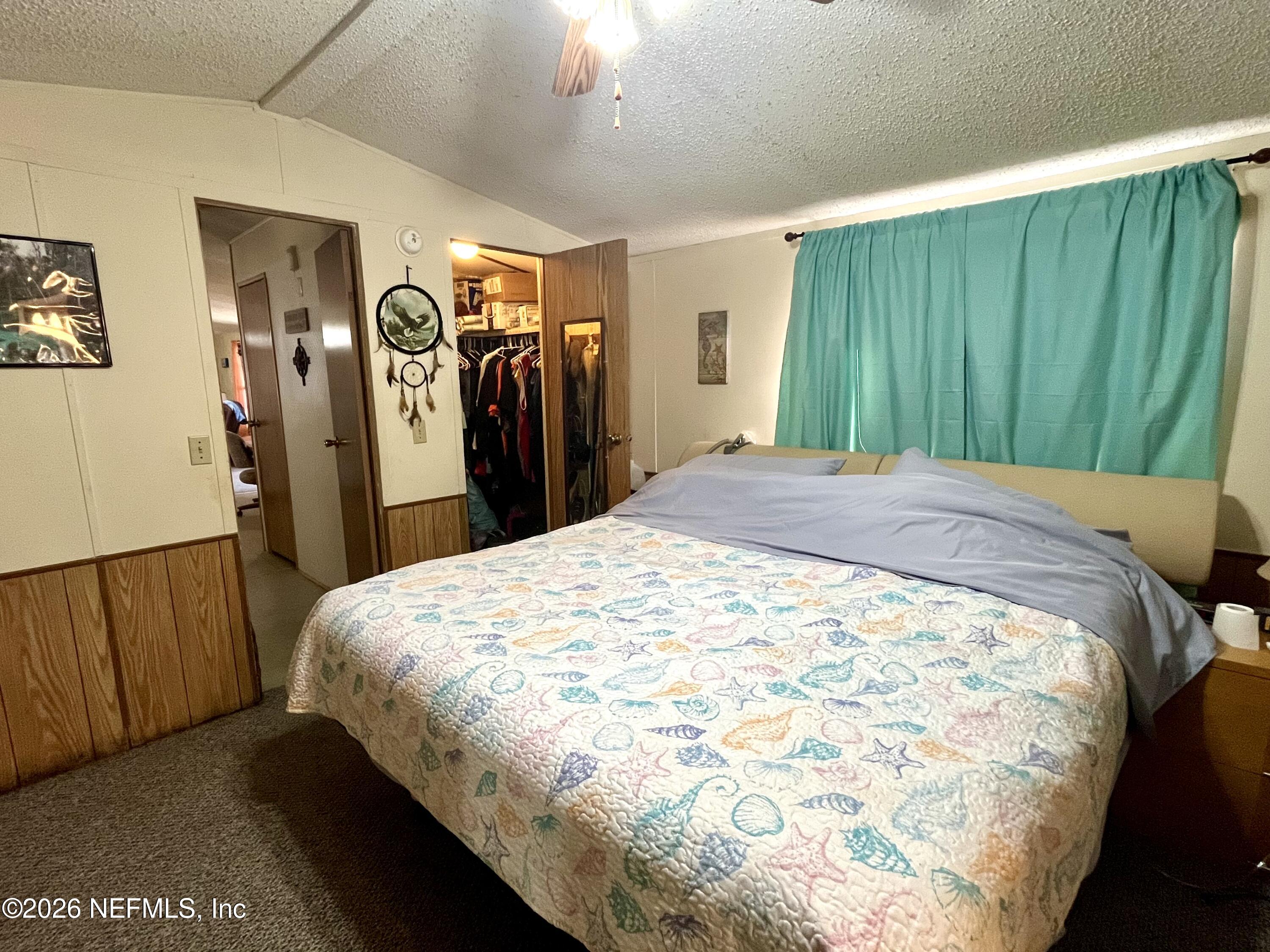 174 Buchanan Circle Satsuma, FL 32189 - Photo 9 of 16 a bed sitting in a bedroom next to a window