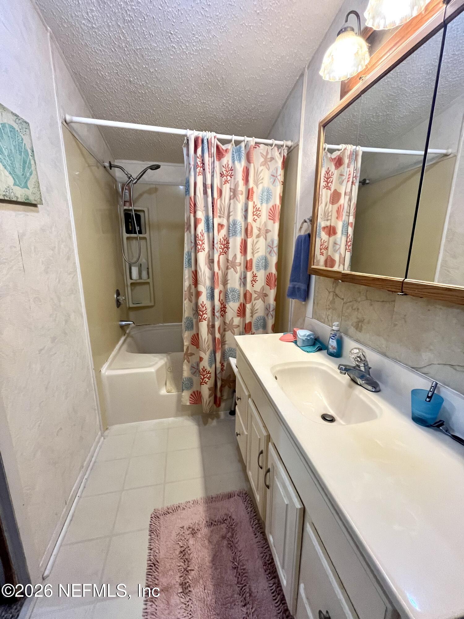 174 Buchanan Circle Satsuma, FL 32189 - Photo 10 of 16 a bathroom with a sink a mirror and a bathtub