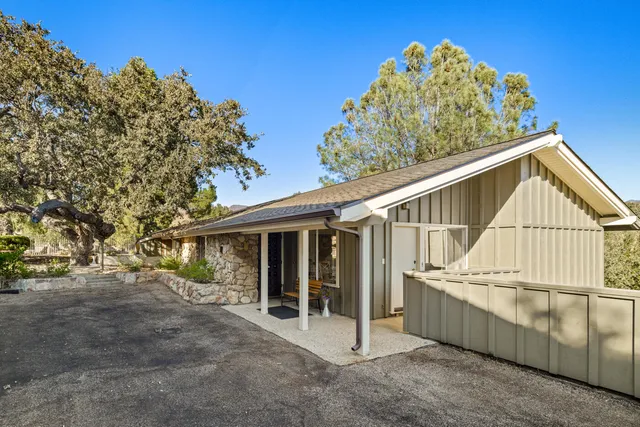 a view of a house with swimming pool and sitting area