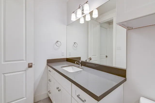 a bathroom with a sink vanity and a mirror