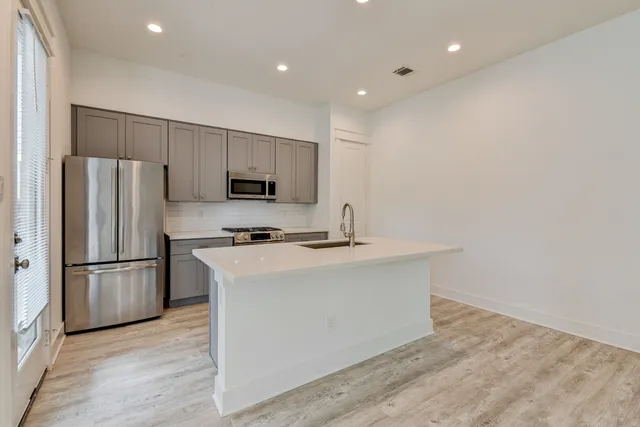 a kitchen with stainless steel appliances a refrigerator and a stove
