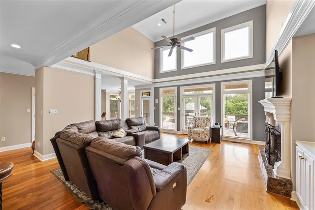 a living room with furniture large window and flat screen tv