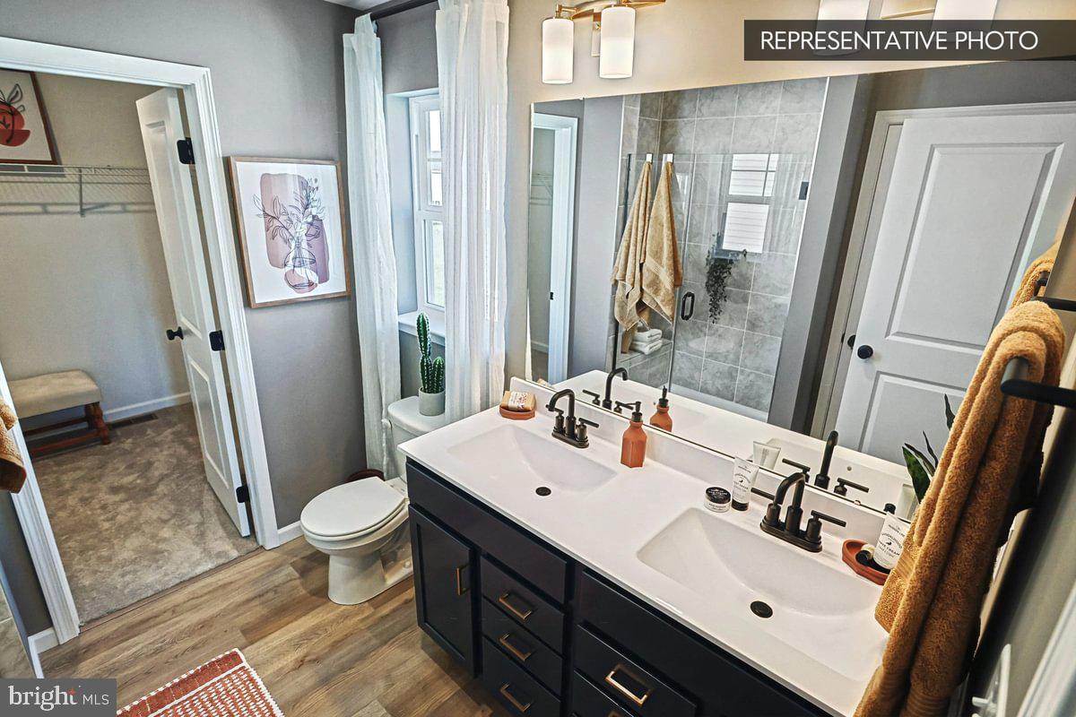 6316 Liam Drive Spring Grove, PA 17362 - Photo 20 of 20 a bathroom with a sink vanity mirror and toilet