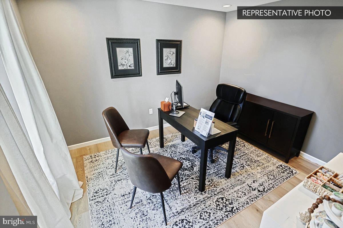 6316 Liam Drive Spring Grove, PA 17362 - Photo 4 of 20 a view of a workspace room with wooden floor and lounge chair