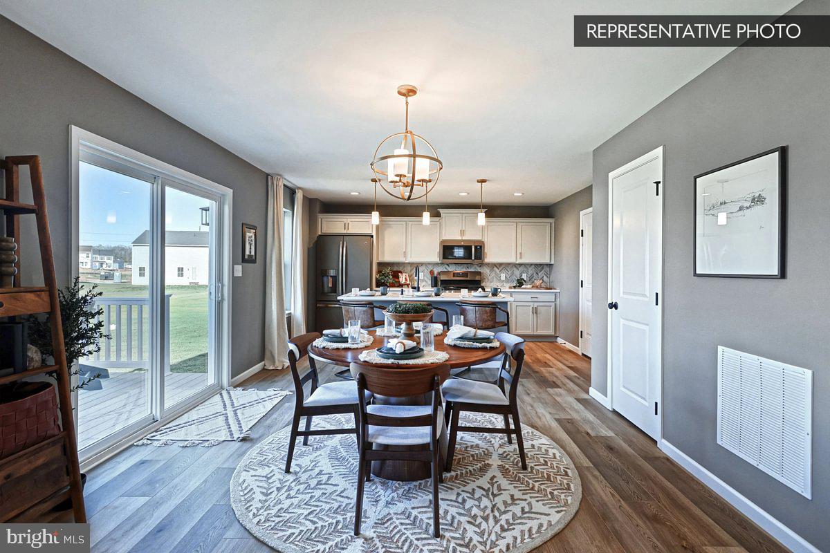 6316 Liam Drive Spring Grove, PA 17362 - Photo 6 of 20 a dining room with furniture a chandelier and wooden floor