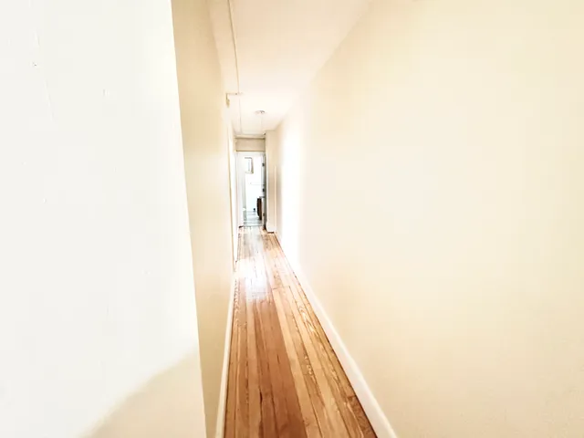 a view of a room with wooden floor