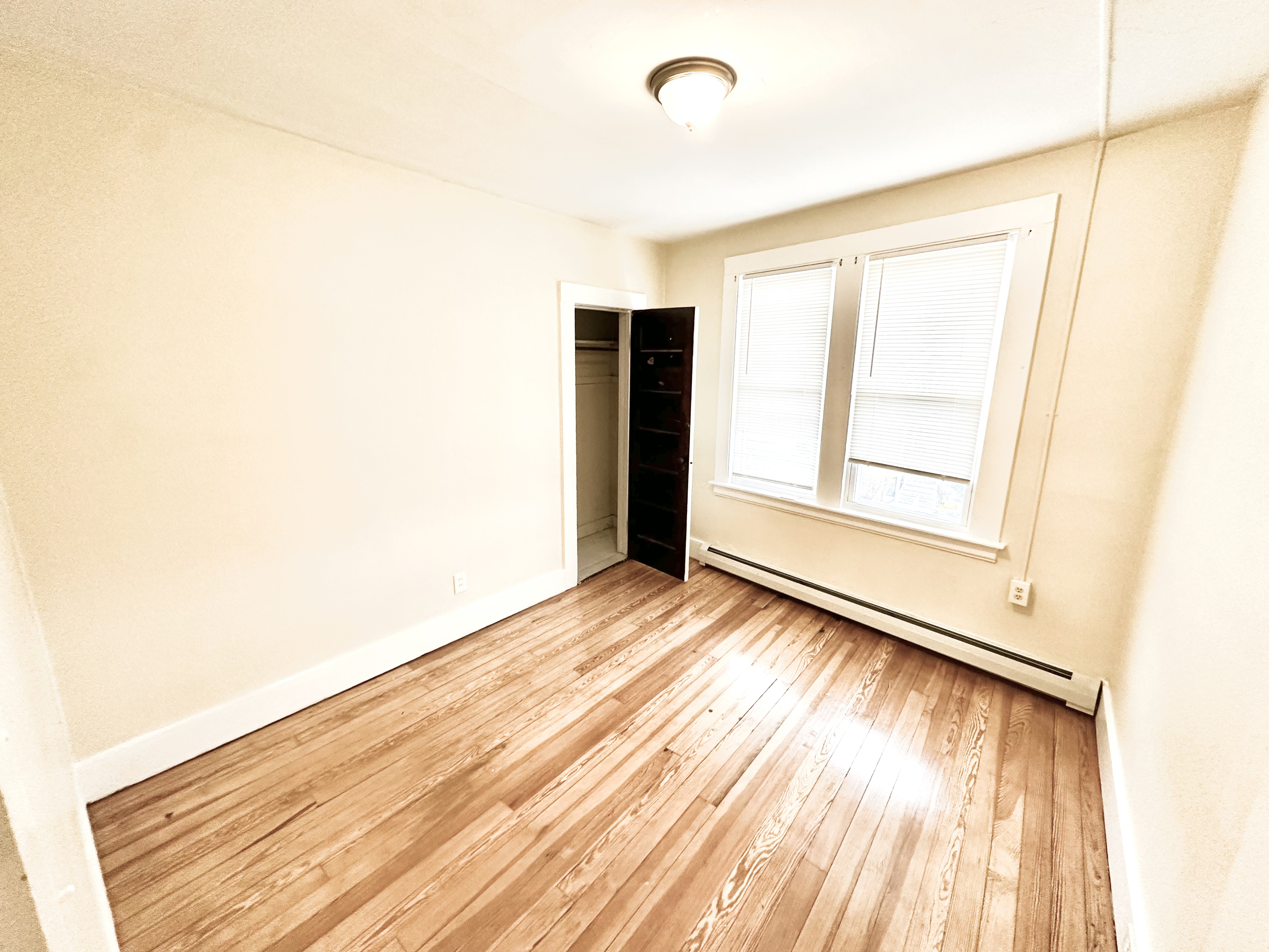 1019 West Main Street, Unit 3L Waterbury, CT 06708 - Photo 13 of 29 a view of an empty room with wooden floor and a window