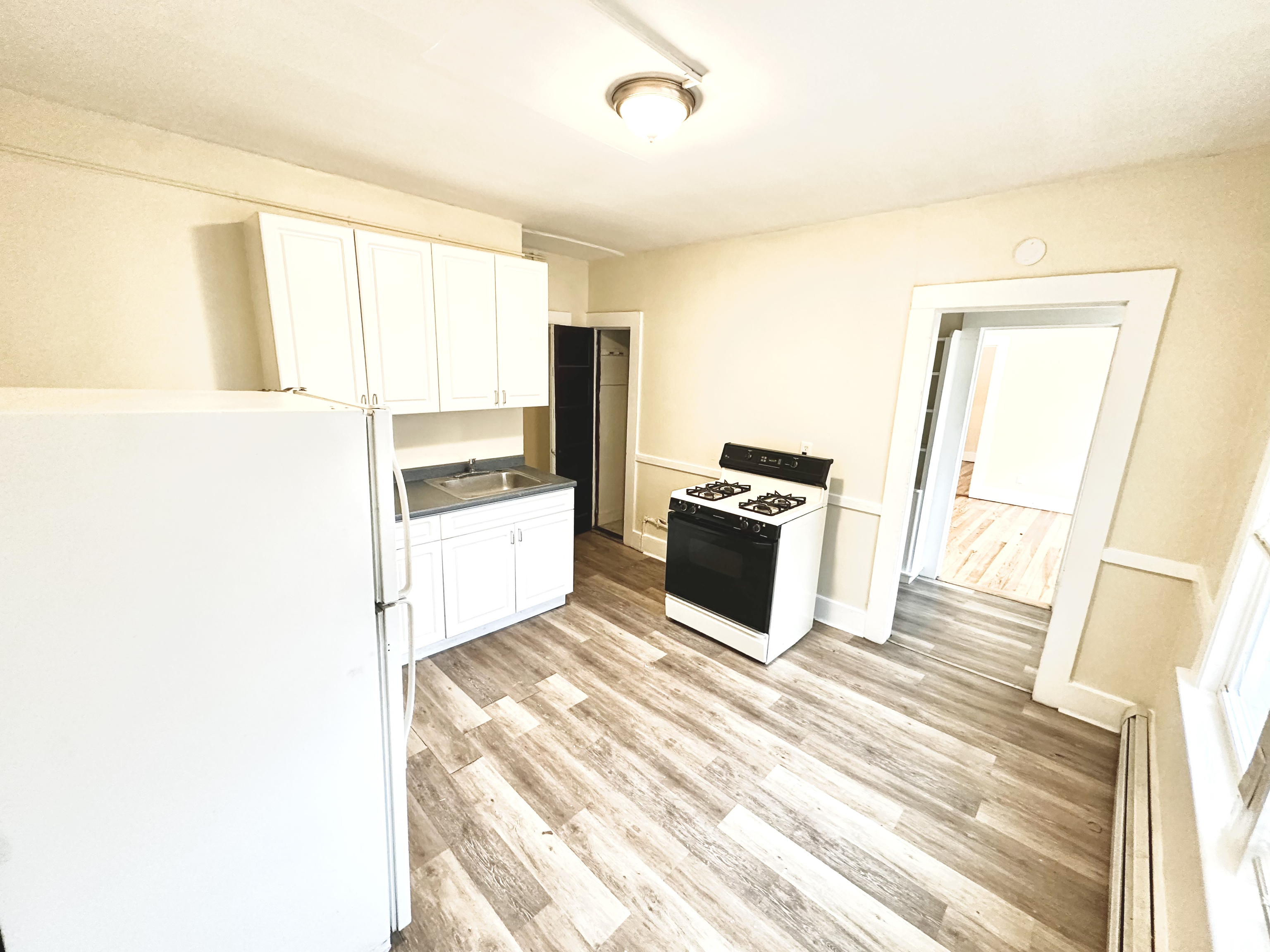 1019 West Main Street, Unit 3L Waterbury, CT 06708 - Photo 17 of 29 a kitchen with granite countertop a refrigerator and a stove