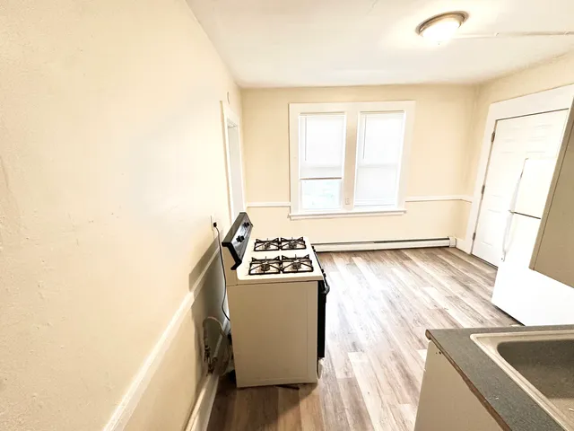 a kitchen with a stove and a refrigerator