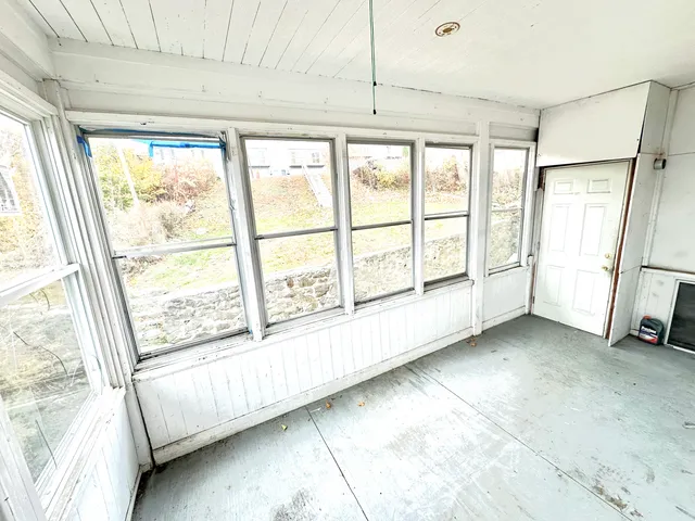 a view of an empty room with a window